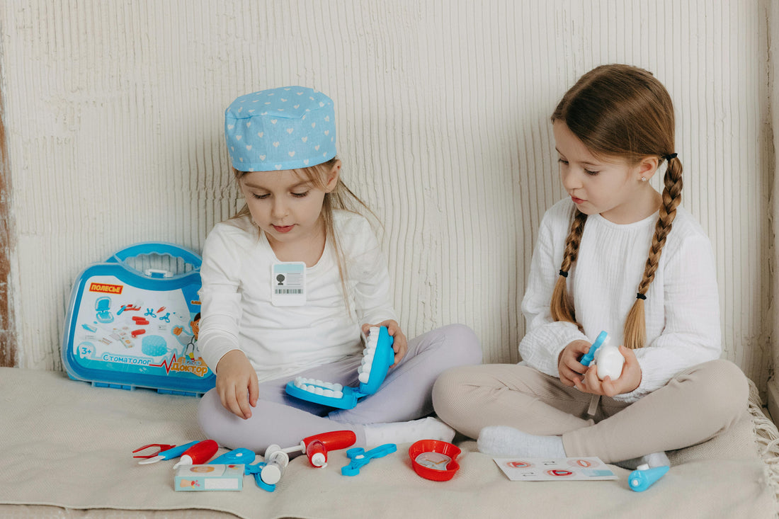 2 girls playing with a doctor set pretending to be doctors